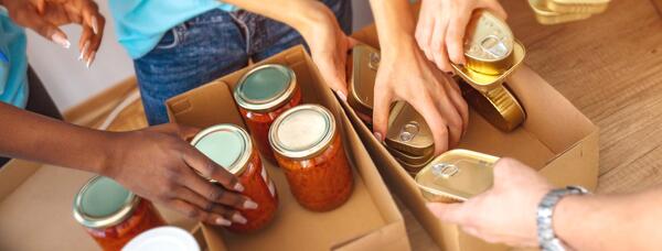 Students and volunteers help stock food bank supplies
