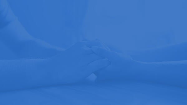 Hands of a student comforting a friend.